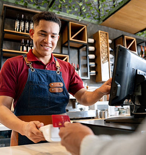 Cuple smiling while drying the dishes and a smart thermostat in the background