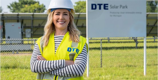 DTE employee wearing hard hat and safety yellow vest standing at a DTE facility