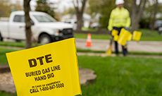 Image of lawn marked with yellow flags indicating gas lines